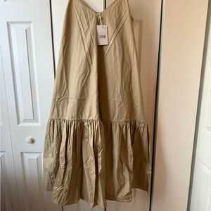 Beige Women's Skirt. 
Hip: 41-58 inches 
Waist: 30-50 inches
It’s very oversized
